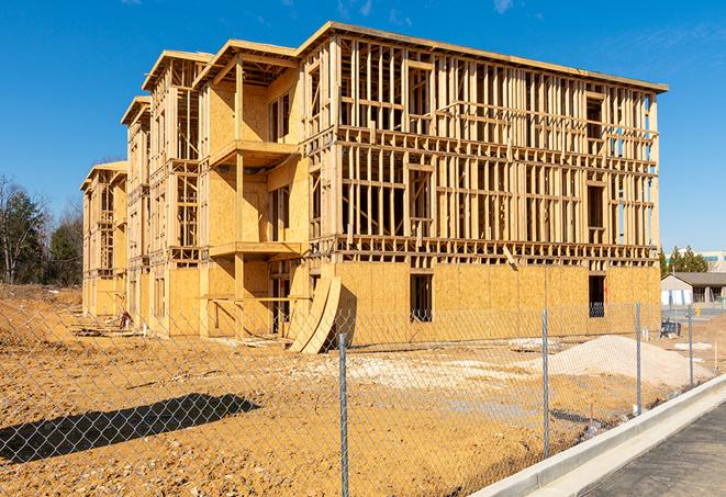 a temporary chain link fence in front of a building under construction, ensuring public safety in Benicia